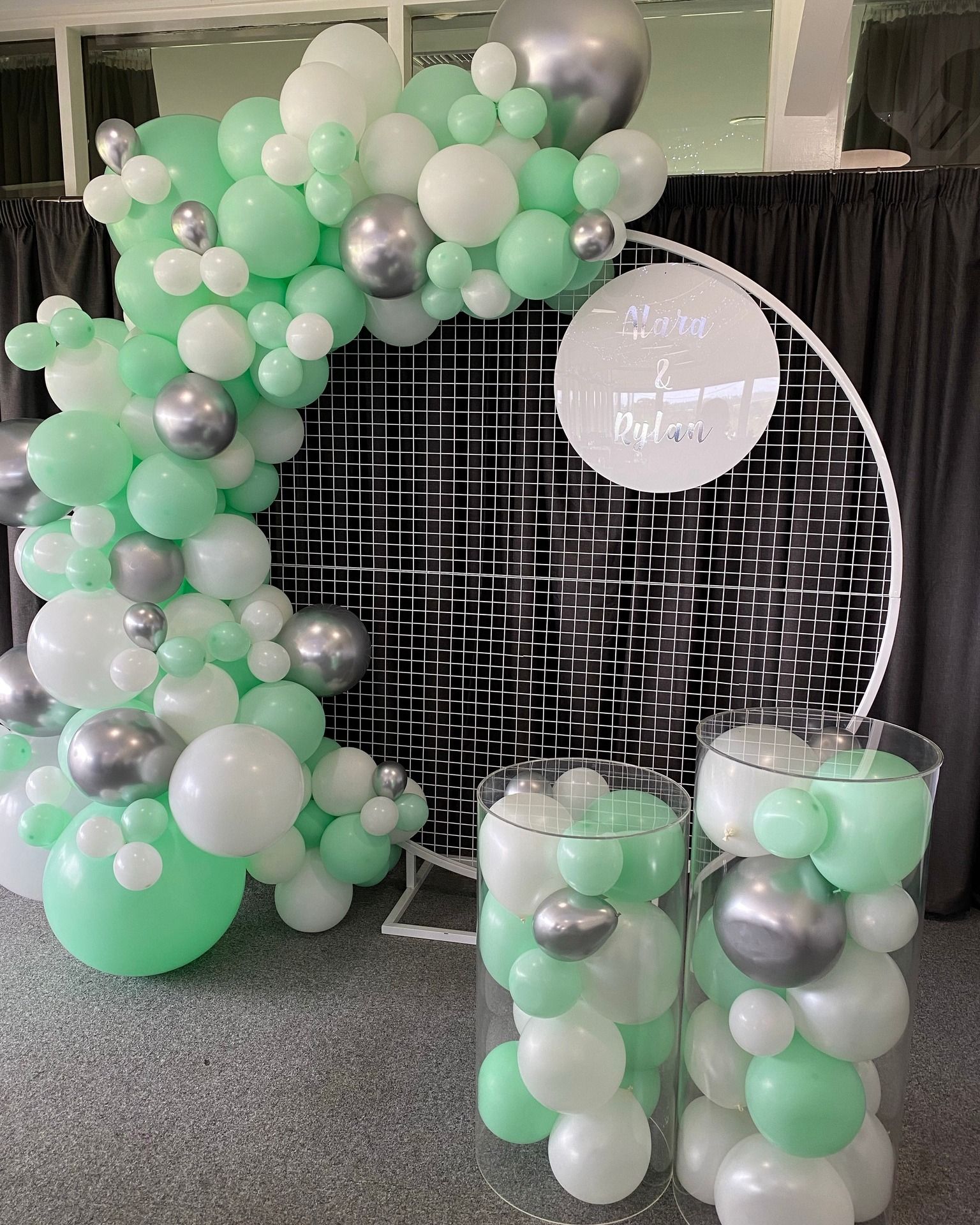White Mesh Backdrop with Balloon Garland and Cake Plinths